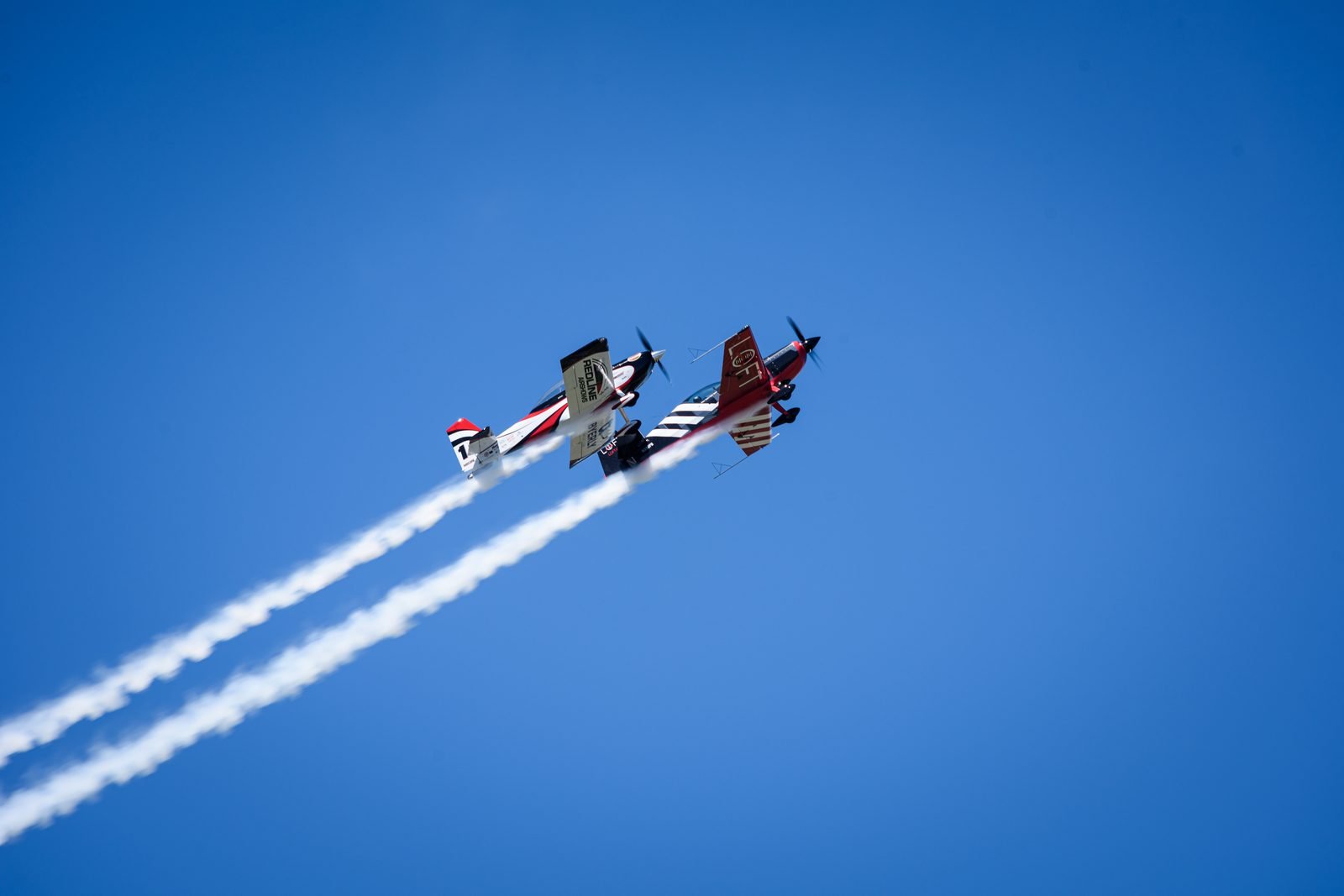 Aerobatic biplane trailing smoke